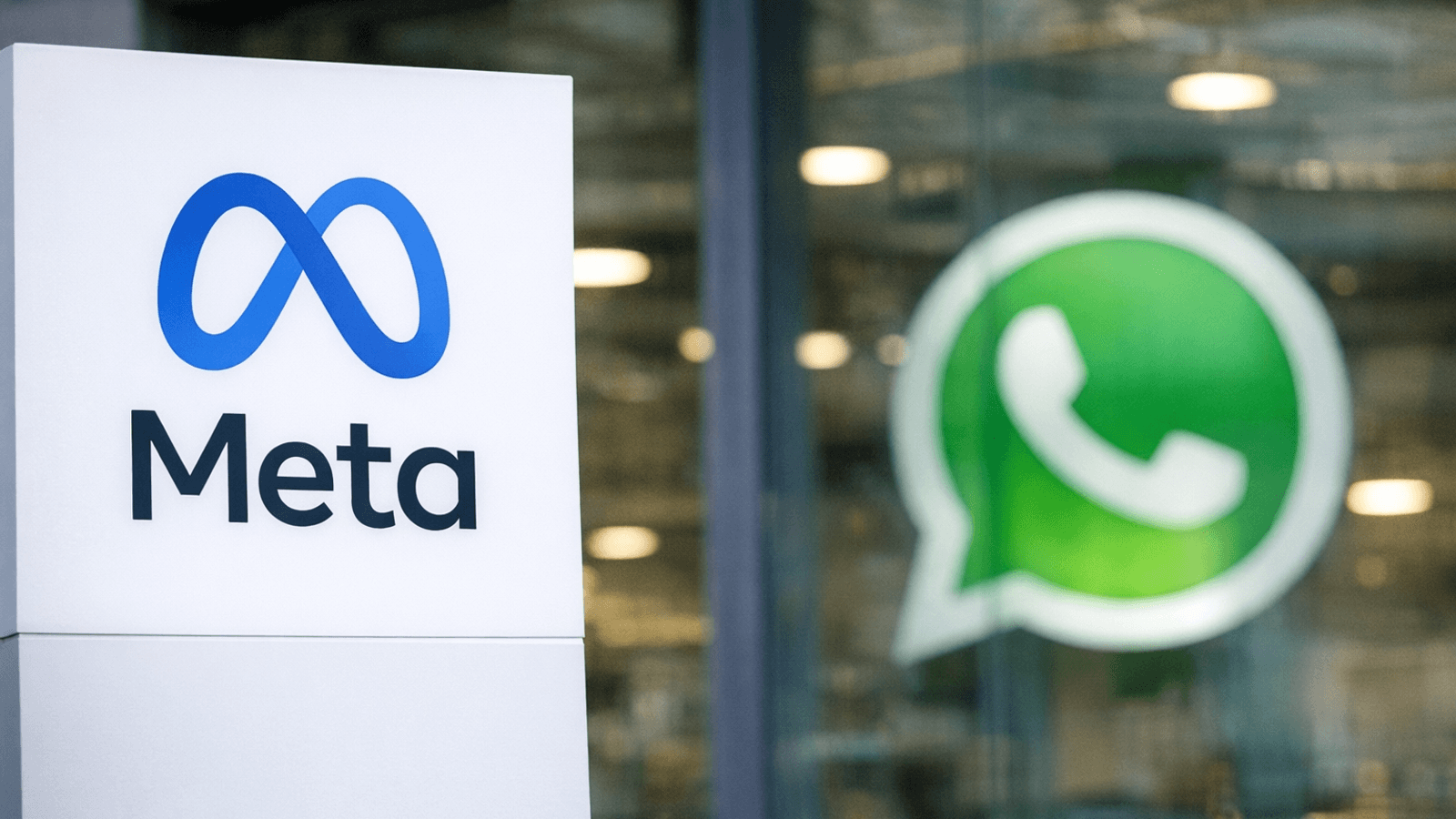A Meta sign in the foreground with a blurred WhatsApp logo in the background, symbolizing regulatory pressure on platform access in Europe.